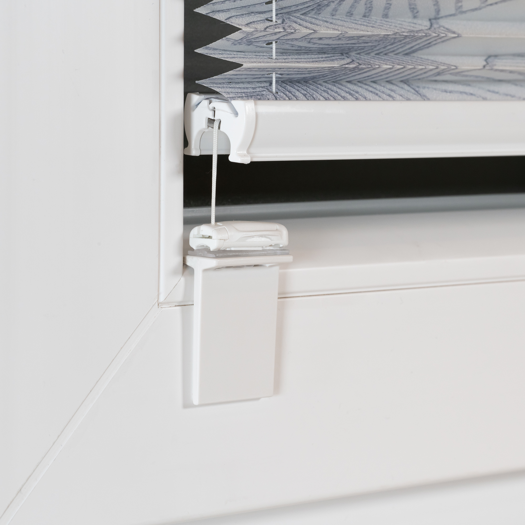 Fenster mit montiertem Plissee-Rollo und Zugmechanismus