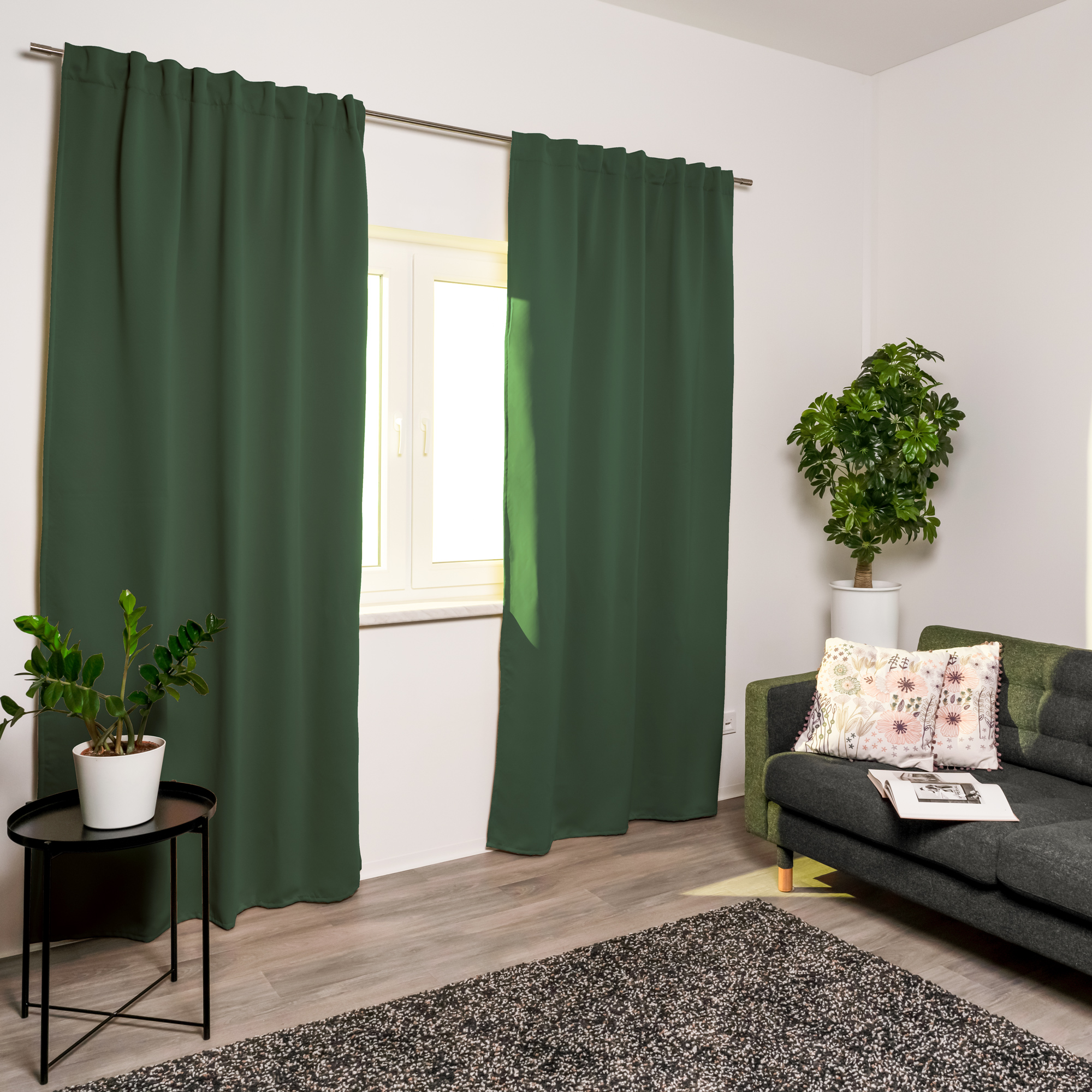 Akustik-Vorhang an Fenster in modernem Wohnzimmer mit Sofa und Pflanzen