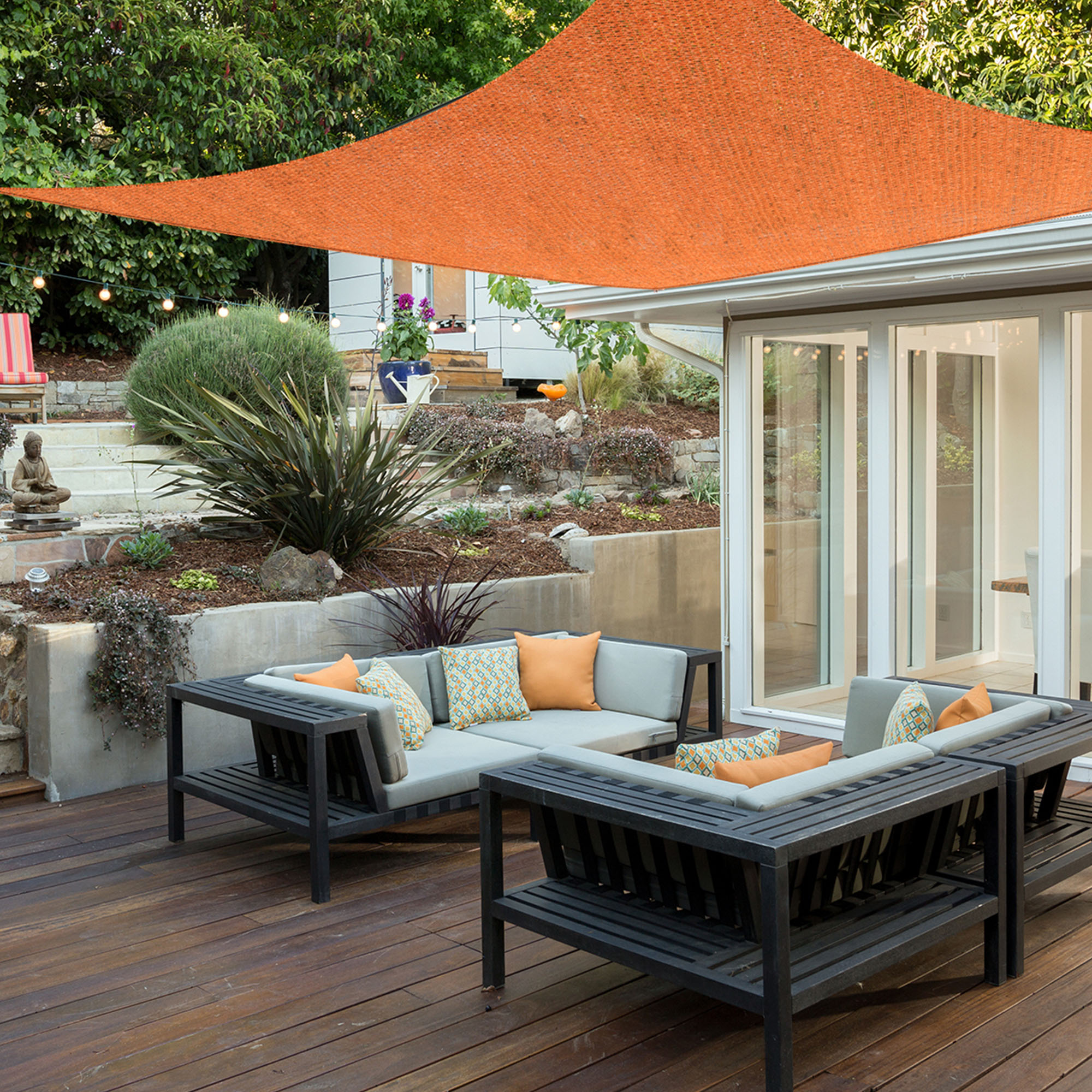 Atmungsaktives HDPE-Sonnensegel über Terrasse mit Sitzbereich und Pflanzen